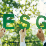 Hands of business team holding ESG text, Environmental, social and corporate governance concept.