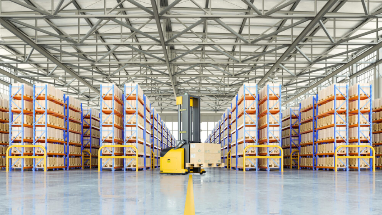 Modern warehouse with automated forklift and organised shelving, representing an advanced warehouse management system in UK for wholesale distributors.