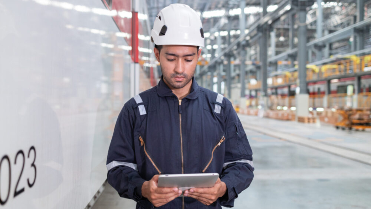 Man using tablet to monitor UK manufacturing floor