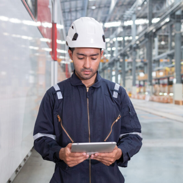 Man using tablet to monitor UK manufacturing floor