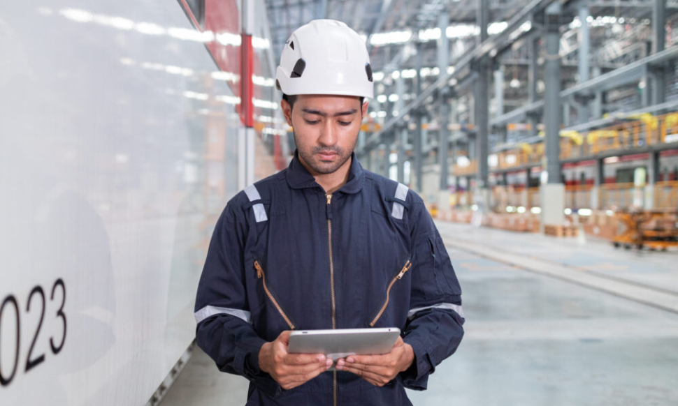 Man using tablet to monitor UK manufacturing floor