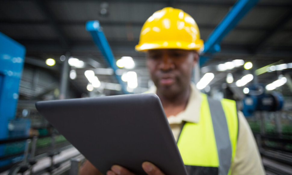 close-up-of-factory-worker-using-digital-tablet-in-project-environment-netsuite-erp