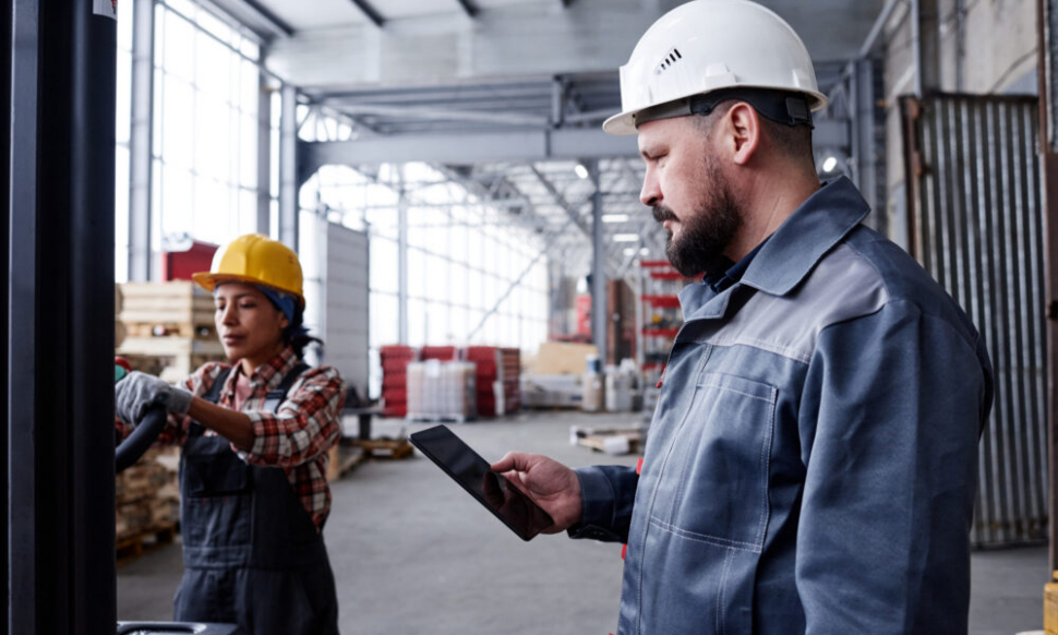 Foreman using a tablet, showing the best field service management software for small business