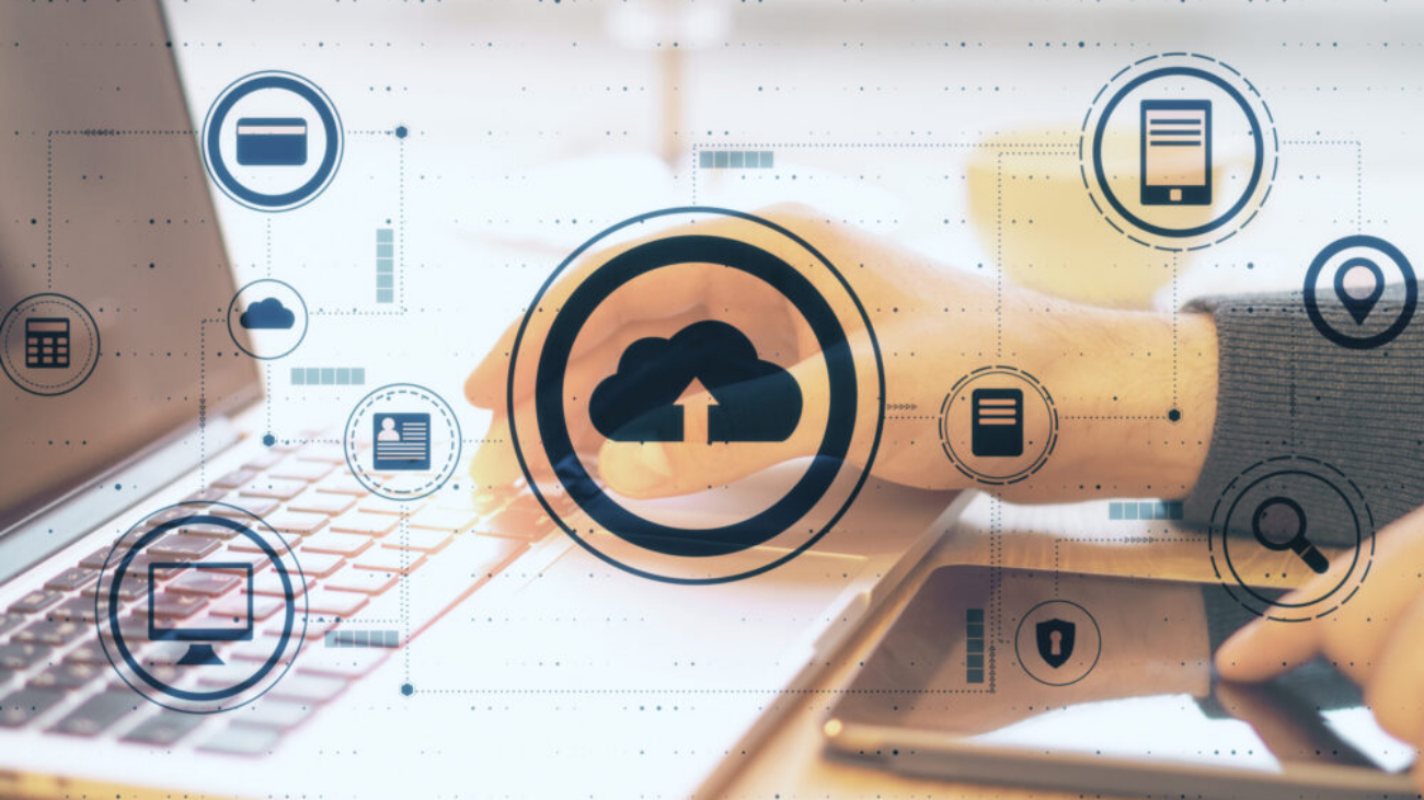 Cloud computing concept with laptop and tablet showing cloud-based ERP dashboard for small business systems