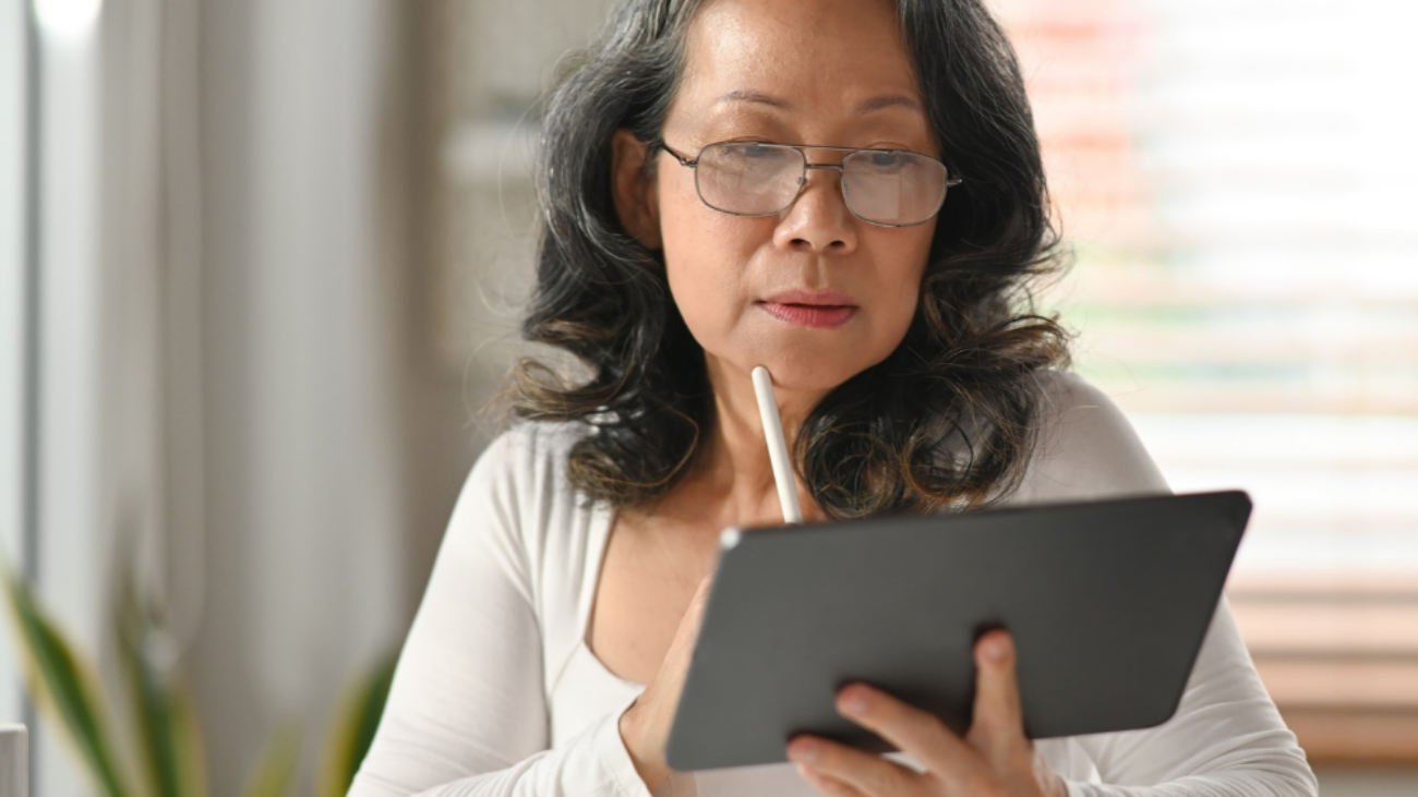 CFO analysing financial reports on a tablet dashboard, showing the benefits of moving to NetSuite ERP