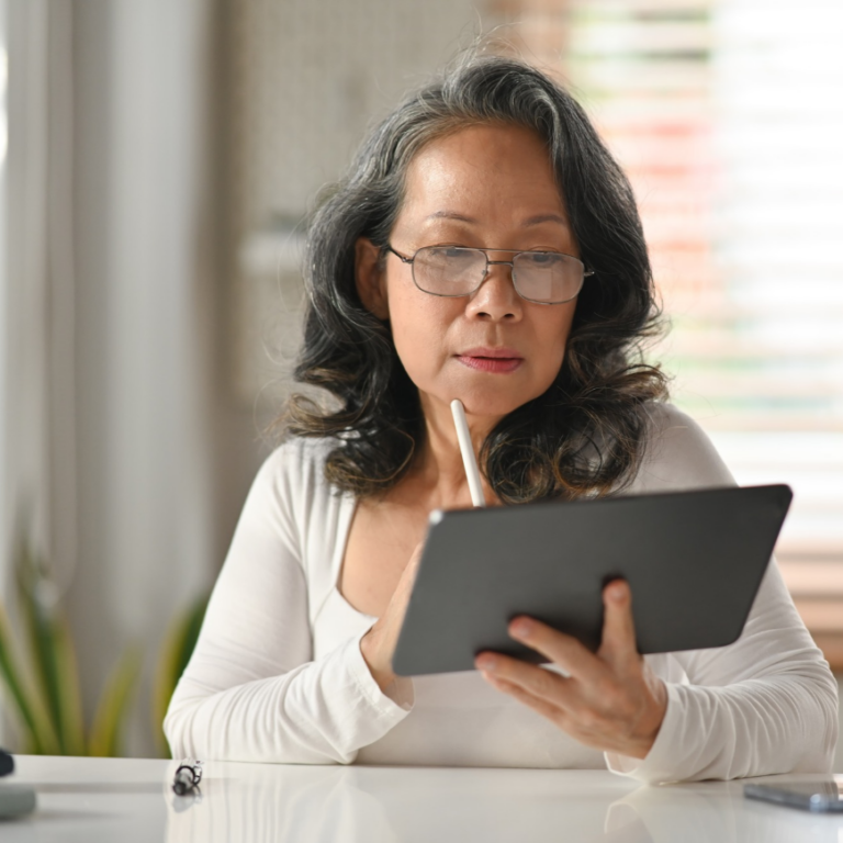 CFO analysing financial reports on a tablet dashboard, showing the benefits of moving to NetSuite ERP