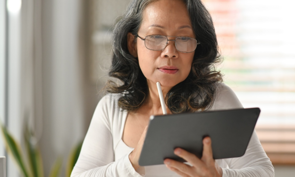 CFO analysing financial reports on a tablet dashboard, showing the benefits of moving to NetSuite ERP